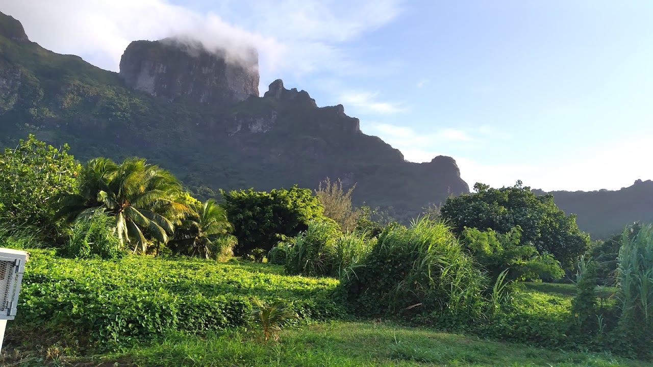 The deep calm harbour of Faanui Bay below green peaks on the northwest coast of Bora Bora