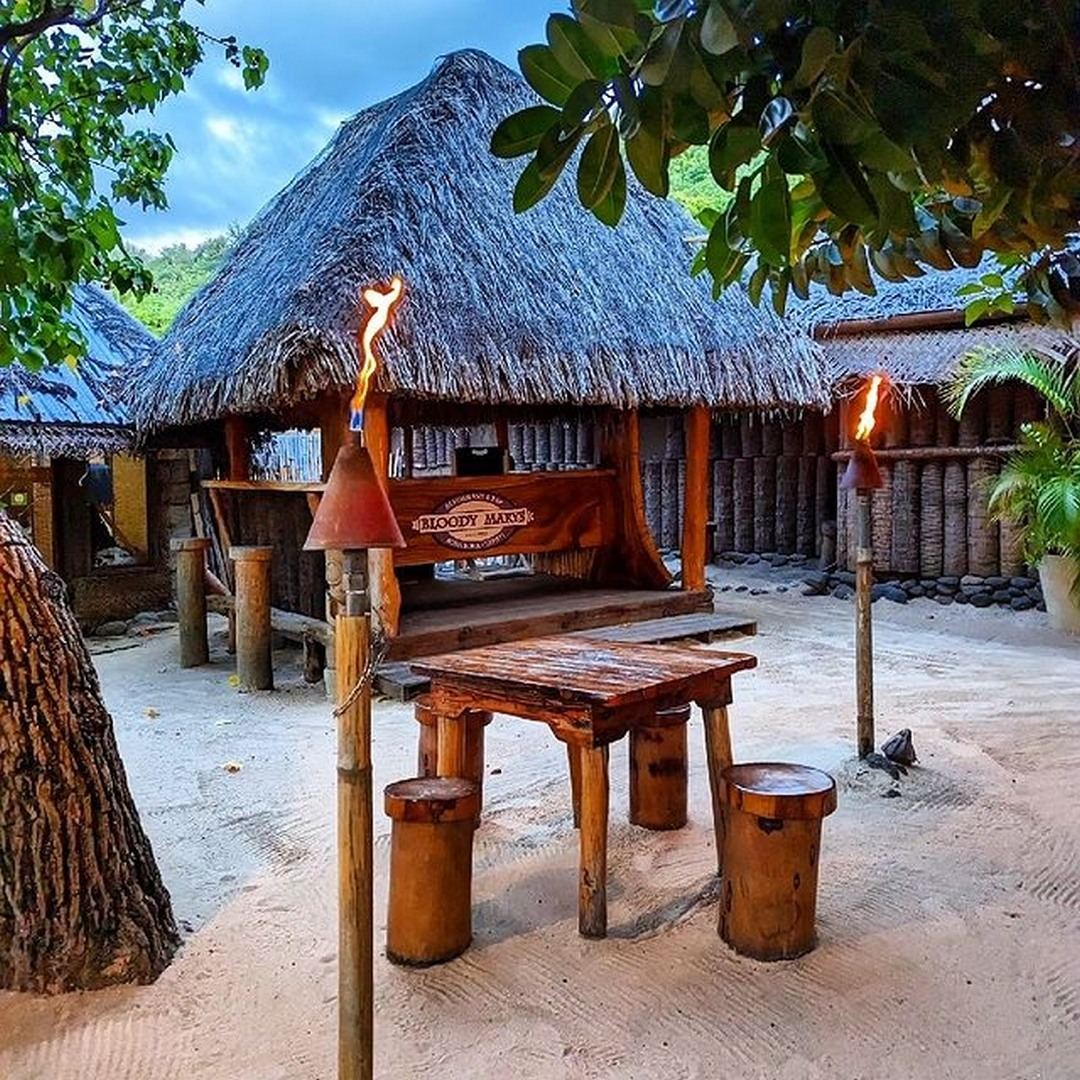 Rustic thatched dining room and fresh catch on ice at Bloody Mary's near Matira Beach
