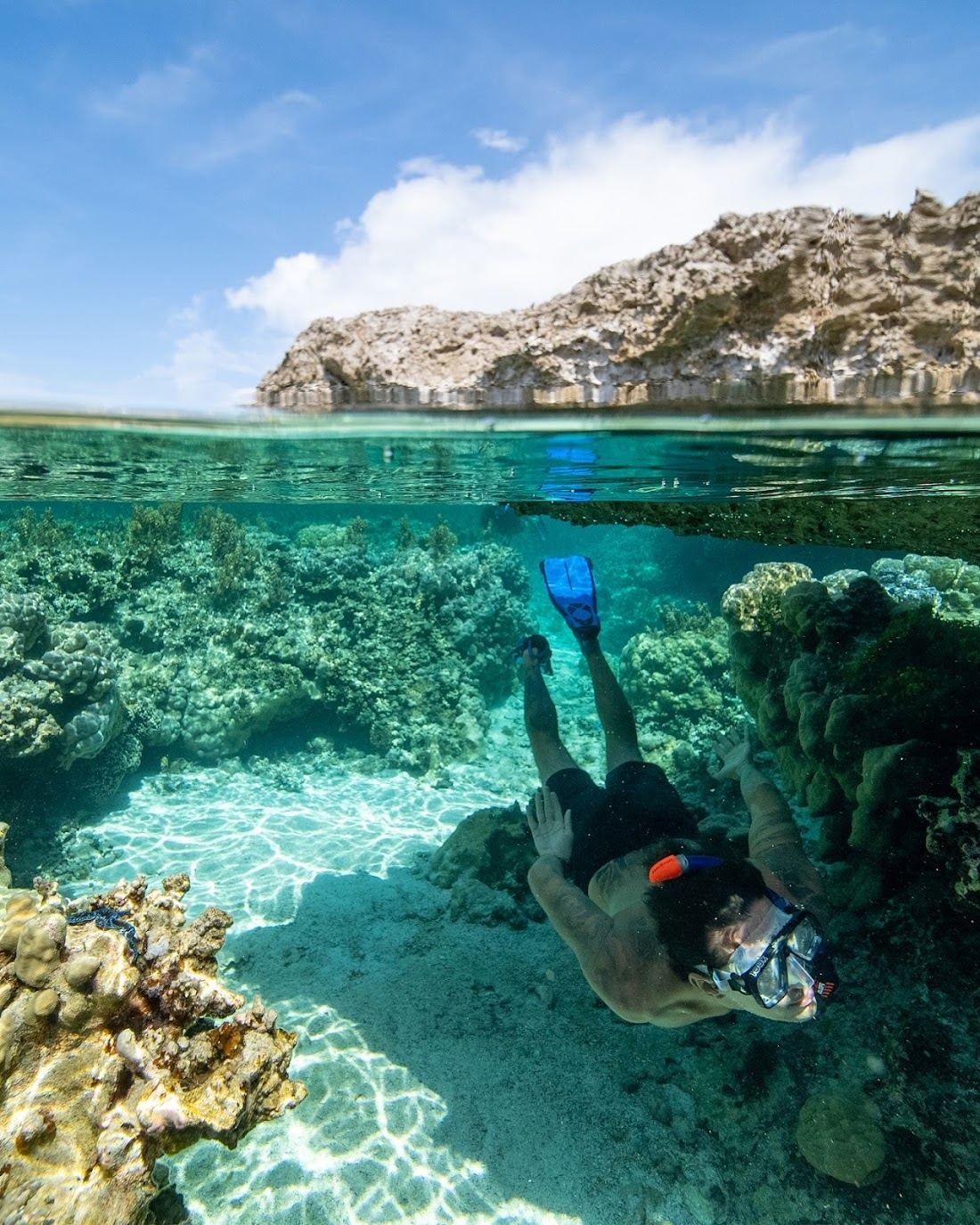 Snorkelling over the reef in the clear lagoon near Motu Piti Aau in Bora Bora