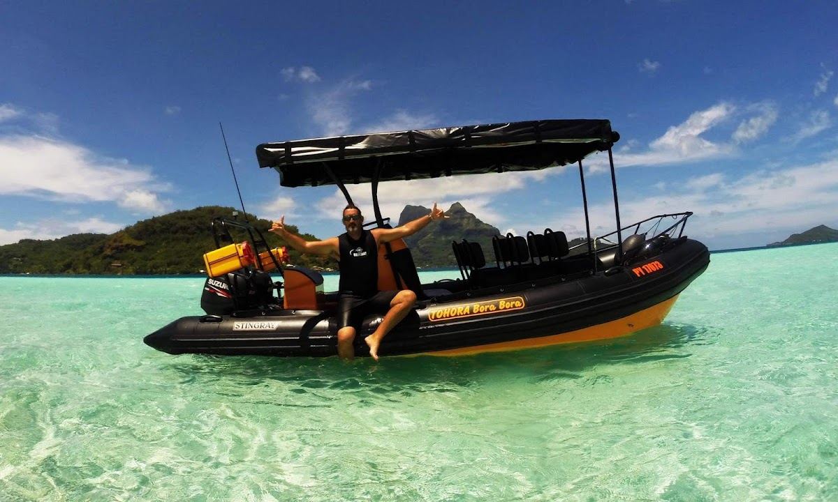 Snorkellers over coral and clear turquoise water on a lagoon tour in Bora Bora