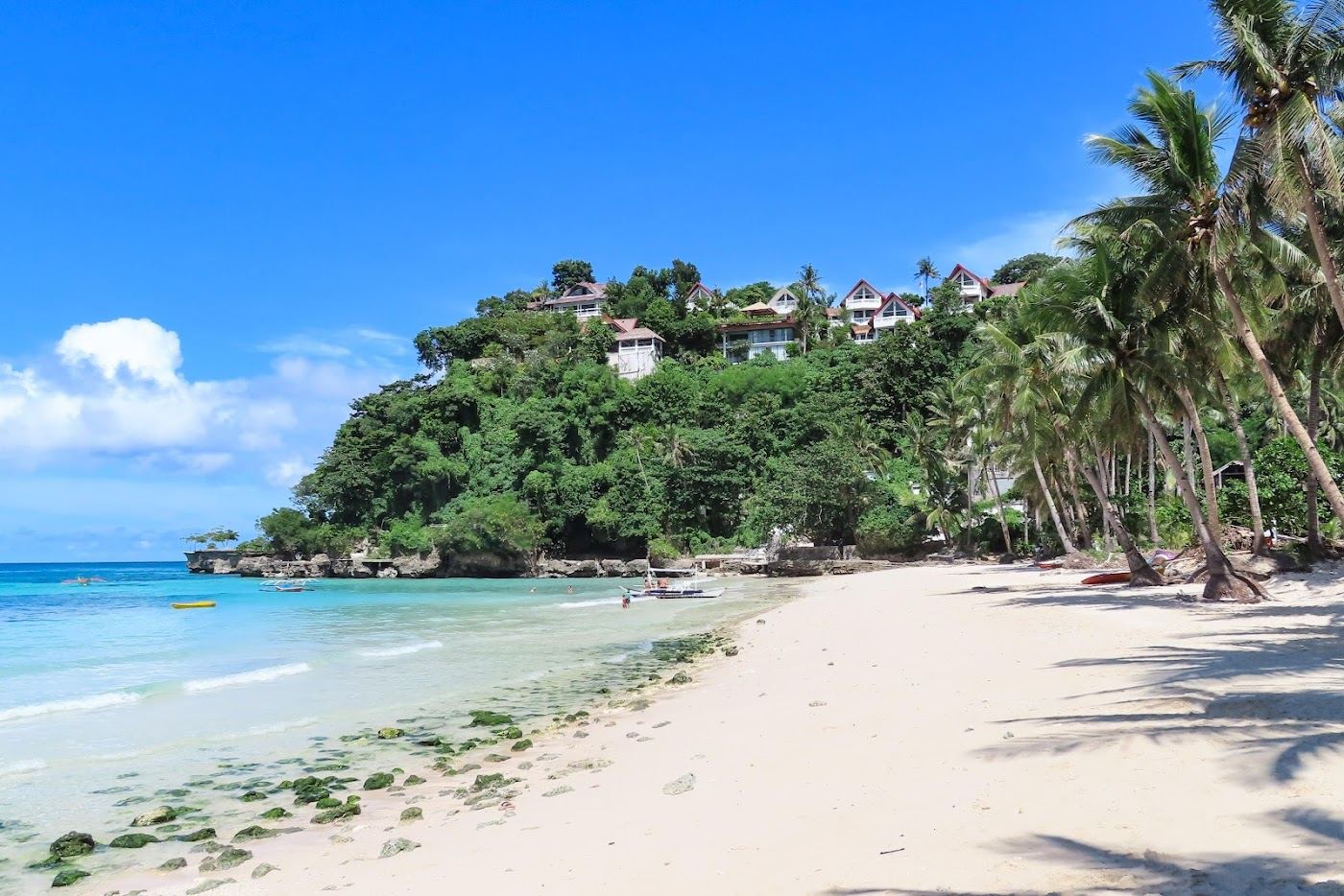 Calm clear water and fine sand in the small quiet cove of Diniwid Beach north of White Beach in Boracay
