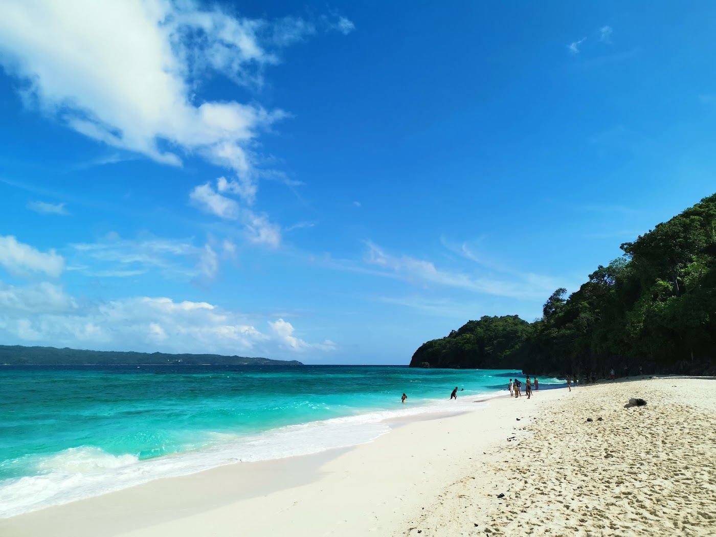 White shell sand and clear water along quiet Puka Beach at the northern tip of Boracay