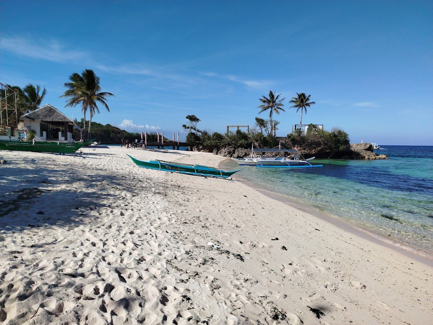Clear calm water over a close reef at quiet local Tambisaan Beach on the southeast coast of Boracay