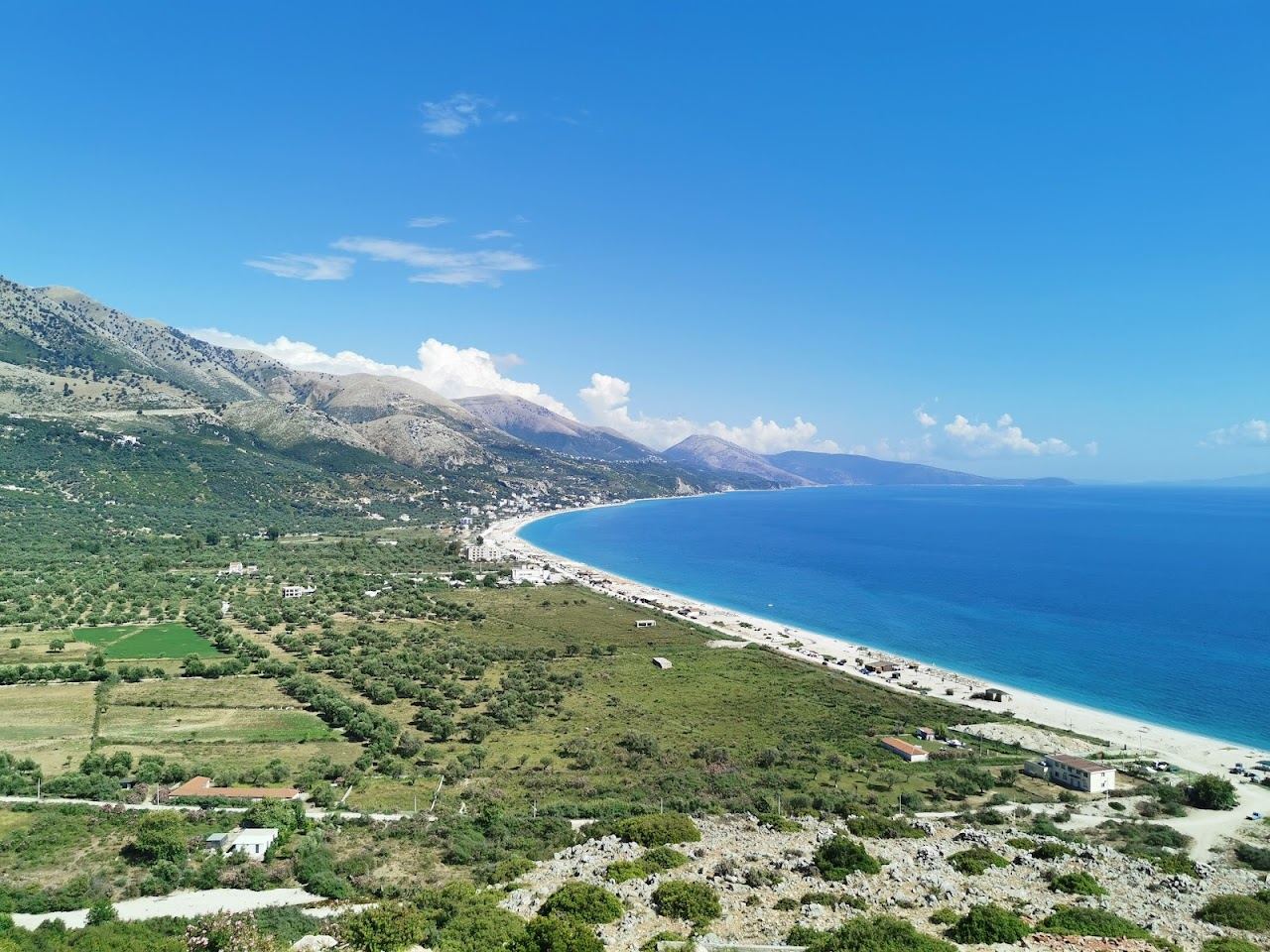 The long open pebble beach at Borsh under the olive groves on the Albanian Riviera