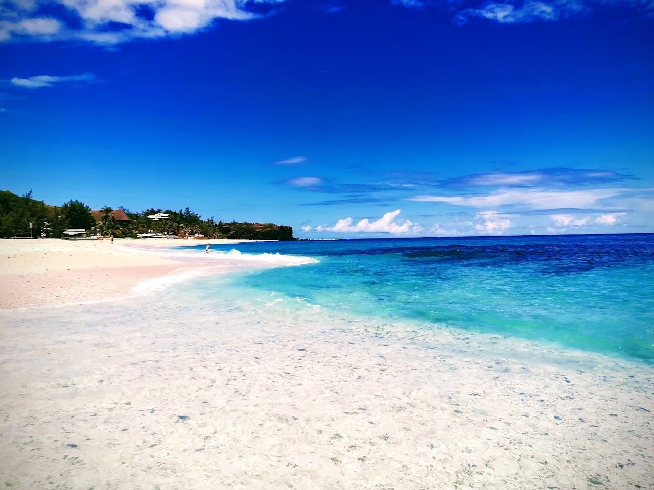 The white sand and open turquoise sea at Boucan Canot beach near Saint Gilles in Reunion