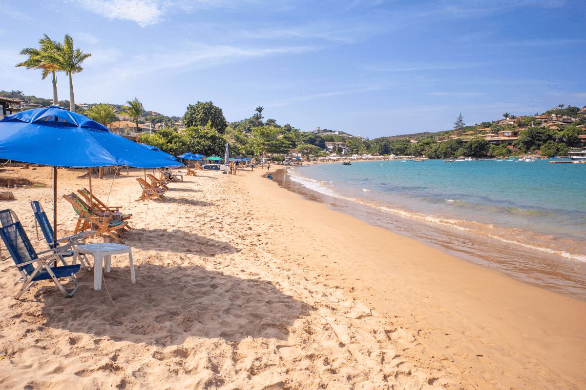 Calm clear water and a curved sandy bay at a beach in Buzios on the coast of Rio de Janeiro state in Brazil