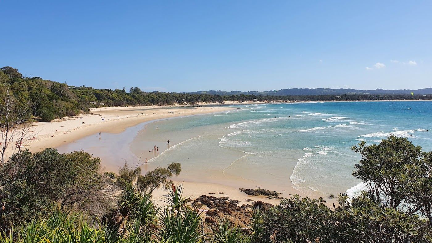 The soft golden sand and sheltered morning water of Clarkes Beach in Byron Bay, New South Wales, Australia