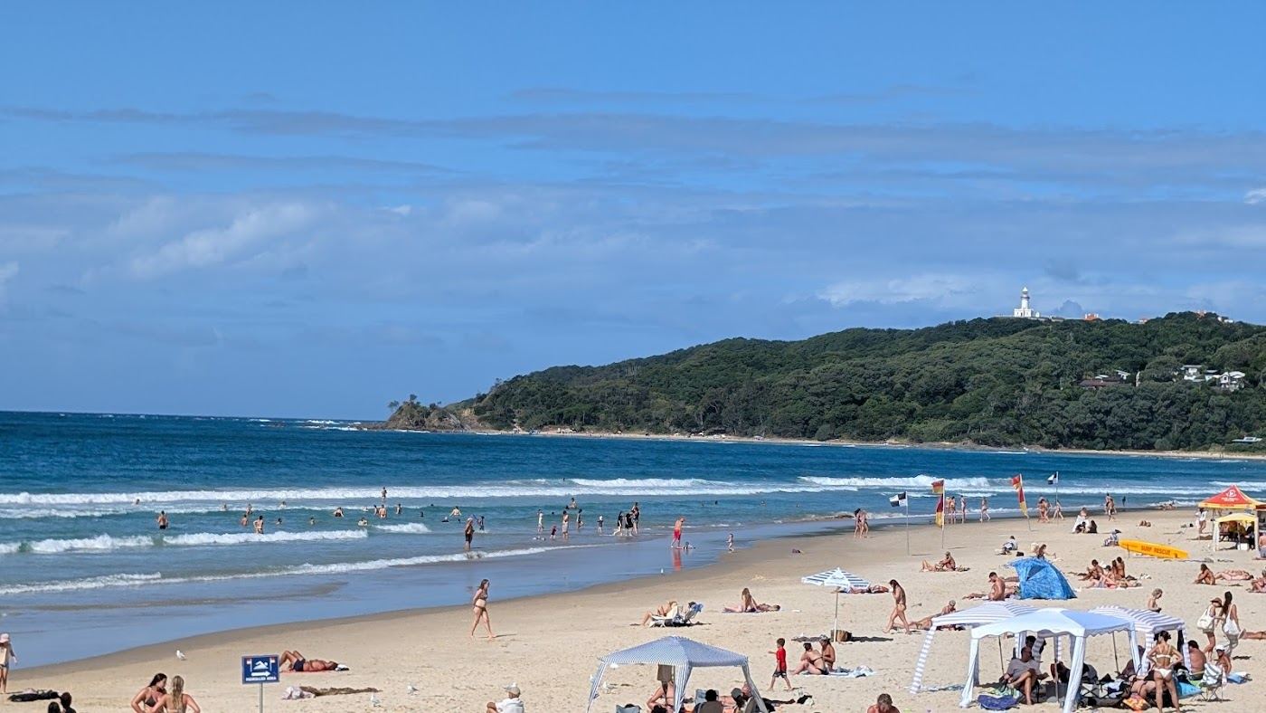 The soft golden sand and gentle morning water of Main Beach in Byron Bay, New South Wales, Australia