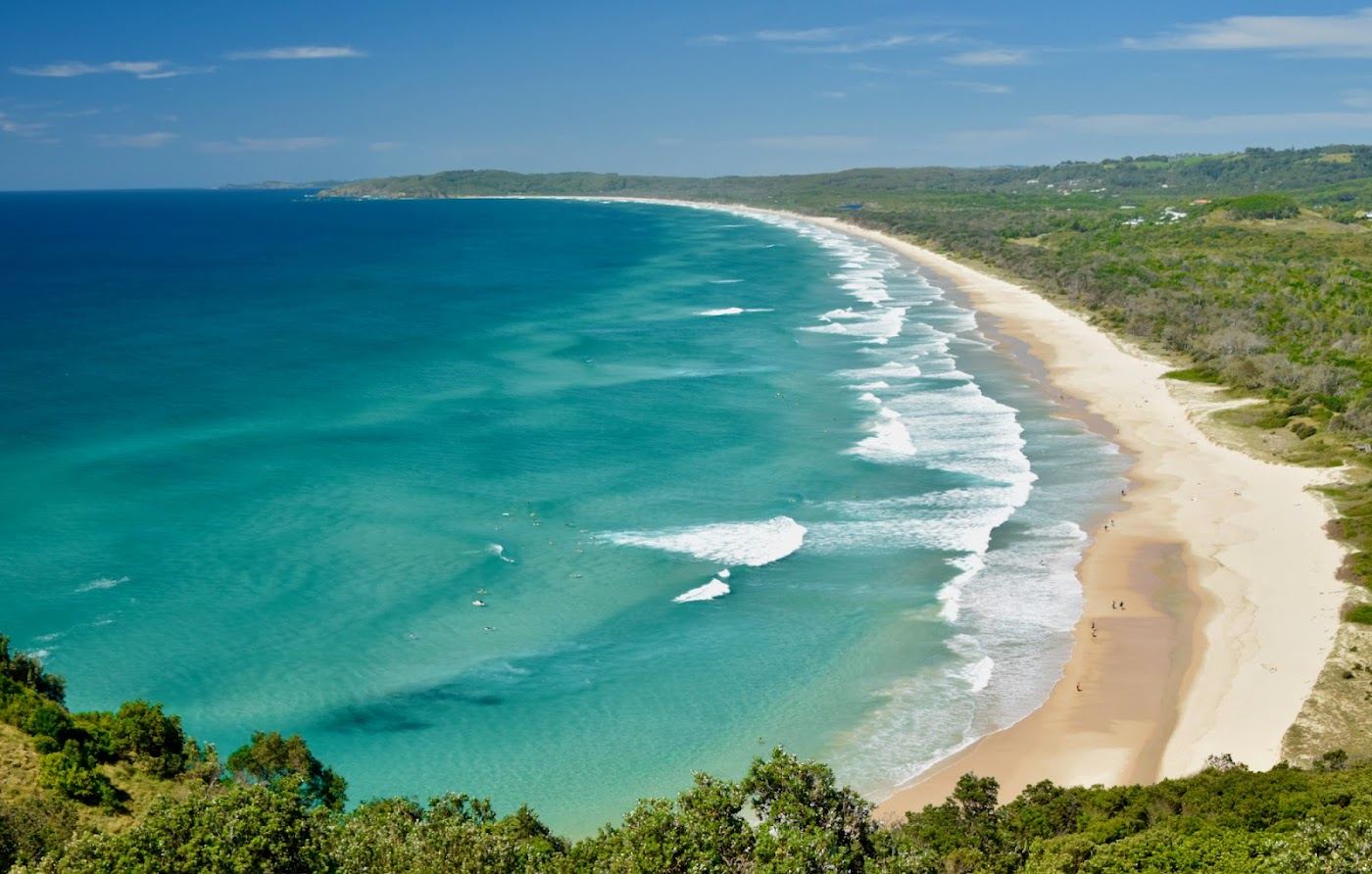 The long wild open sand and dunes of Tallow Beach below the cape in Byron Bay, New South Wales, Australia