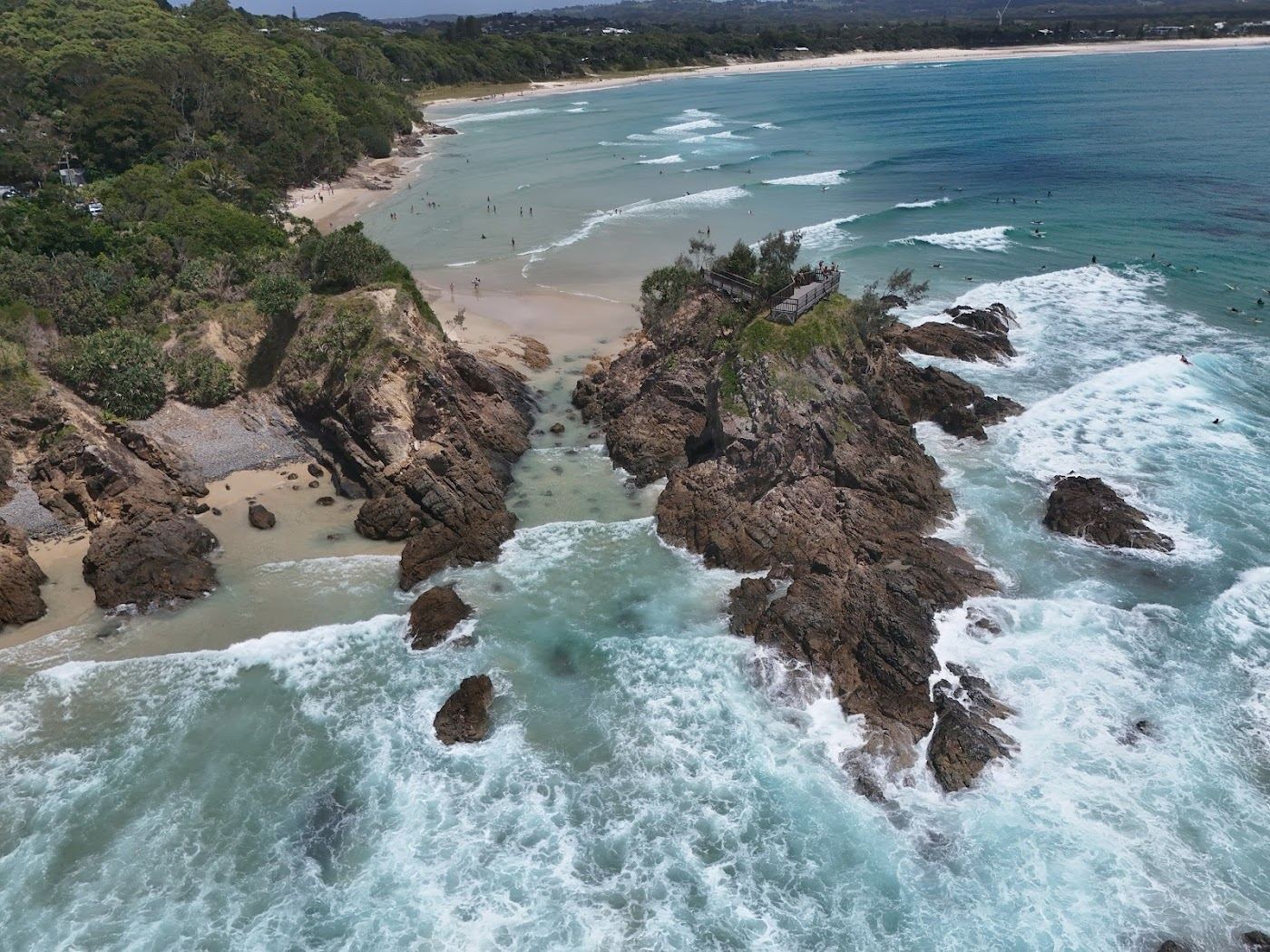 The point break, clear water and headland of The Pass at the eastern end of Byron Bay, New South Wales, Australia