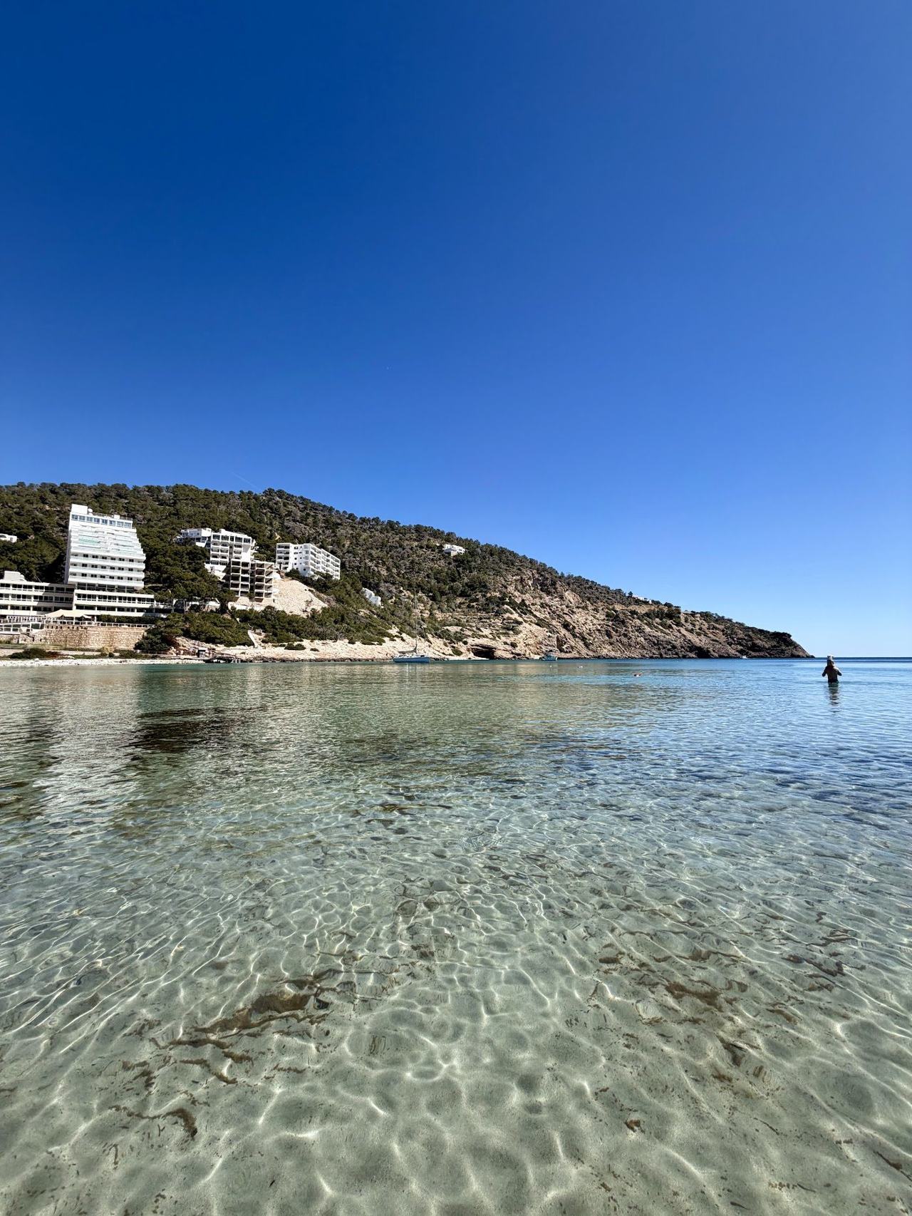 The long sheltered inlet of golden sand and calm water at Cala Llonga on the east coast of Ibiza