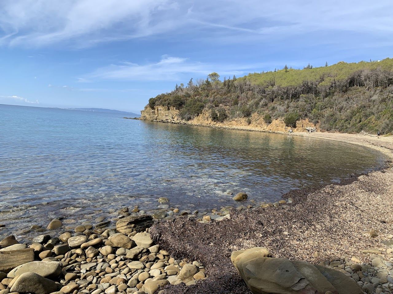 The clear water and rocky shore of Cala Martina in the Scarlino reserve