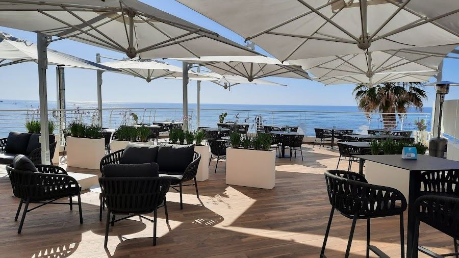 Beach bar and loungers at sunset at Sunset Beach Club on Tropea beach in Calabria