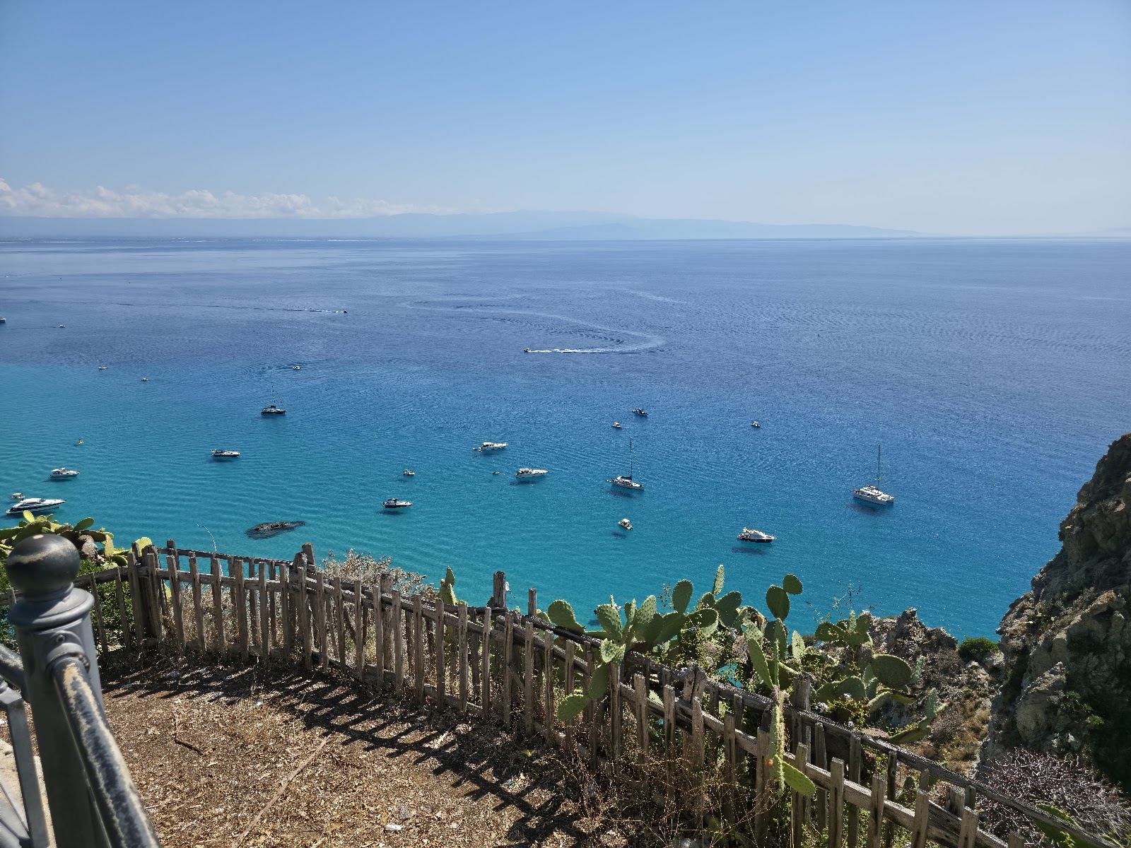 Turquoise water and cliffs along the Capo Vaticano coast of Calabria under summer light