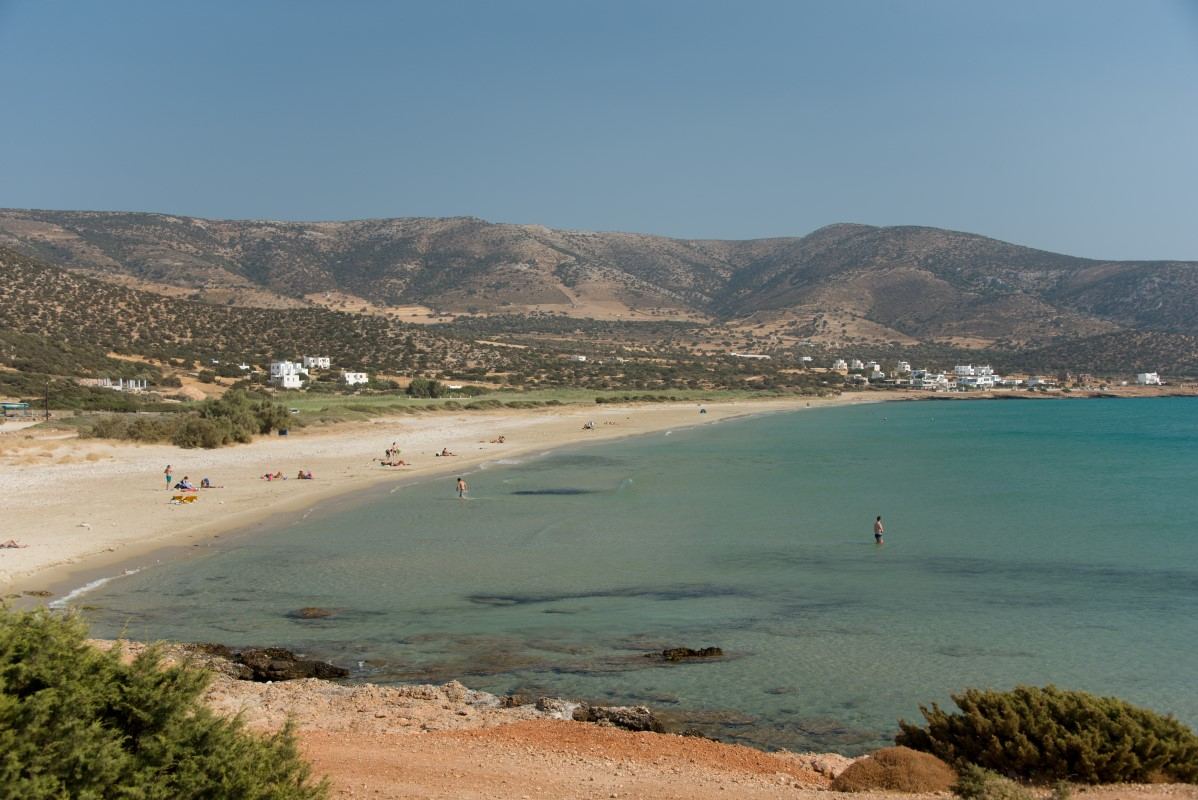 A sheltered Naxos bay with calm, clear, shallow water and fine sand on a still morning