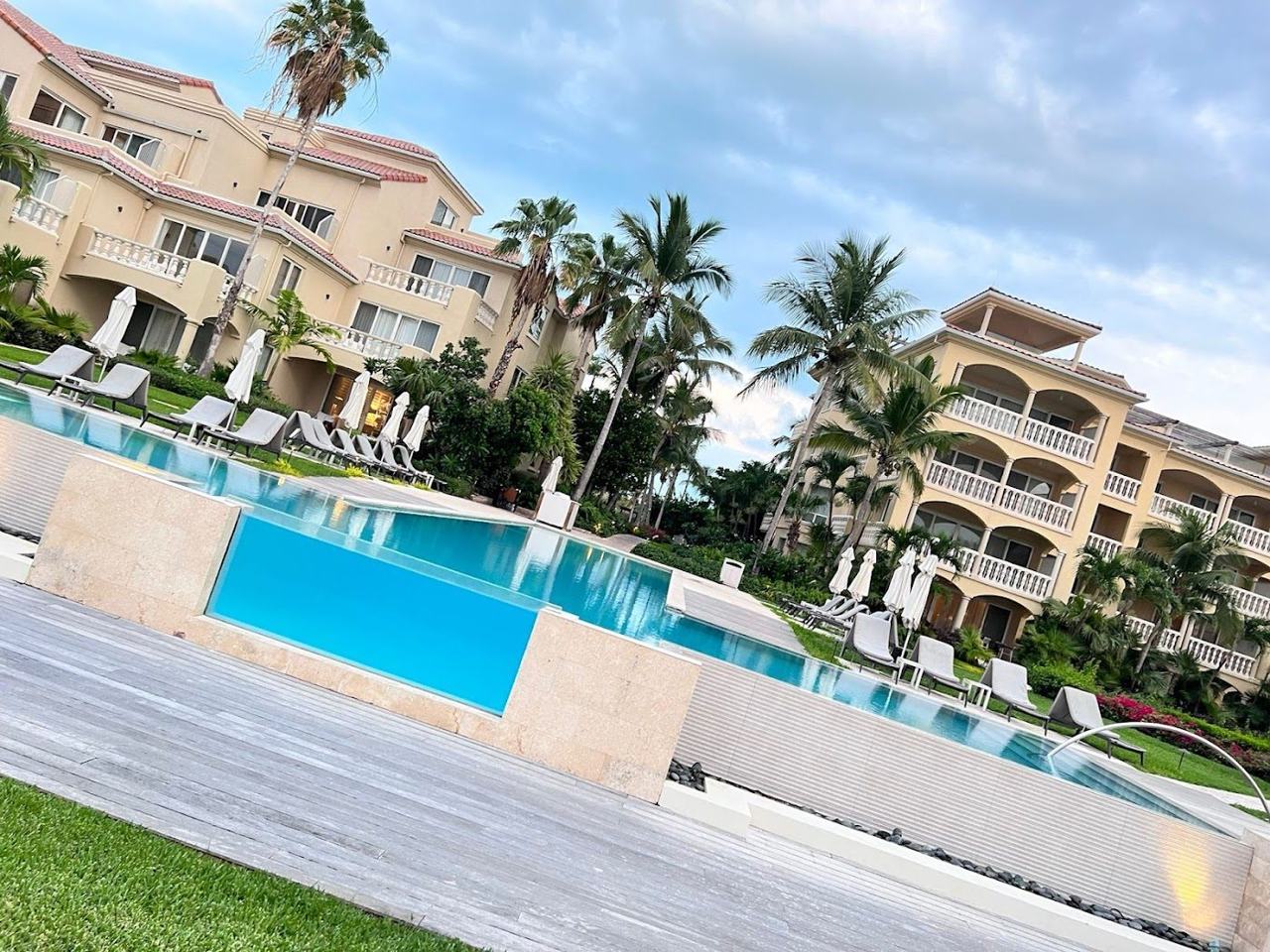 Loungers and a beach bar on the white sand of Grace Bay in front of Grace Bay Club