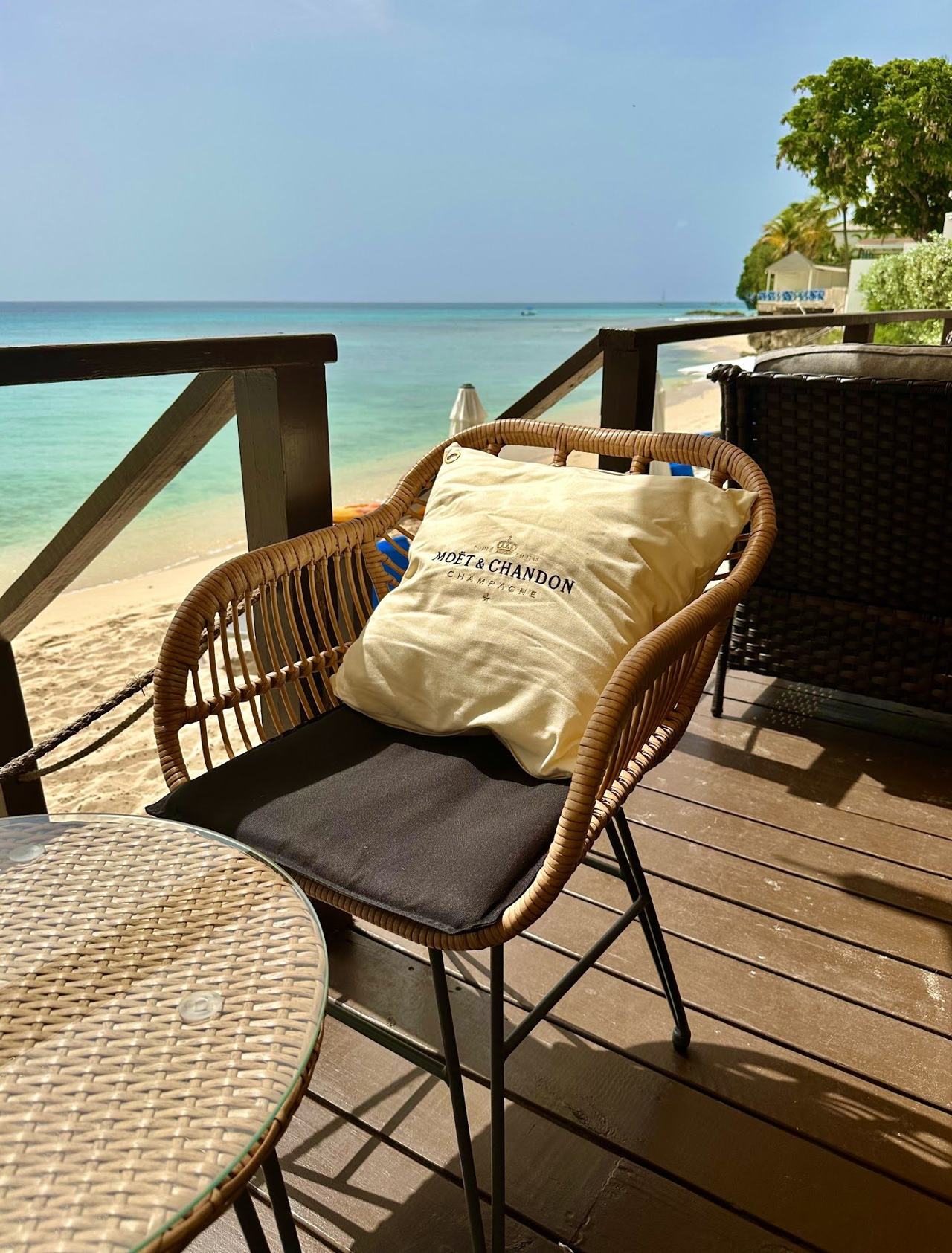 A beach bar with loungers looking out over turquoise water on the south coast of Barbados