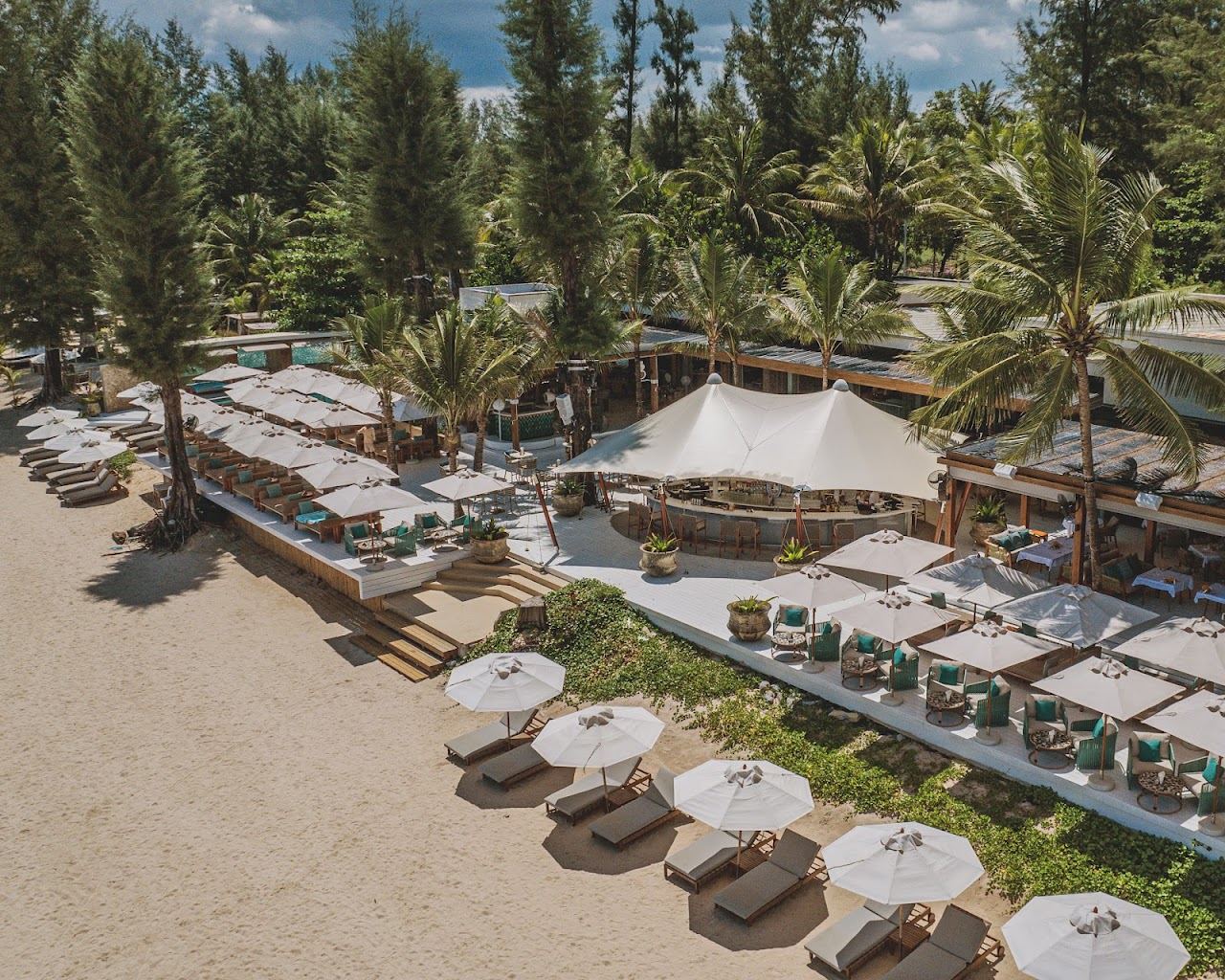 Oceanfront sunbeds and pool at Catch Beach Club on Bang Tao beach in Phuket