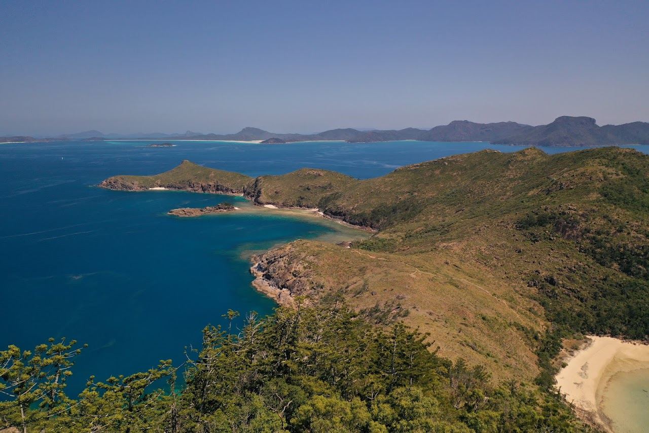 Clear water and wooded slopes around Cateran Bay on Border Island in the Whitsundays