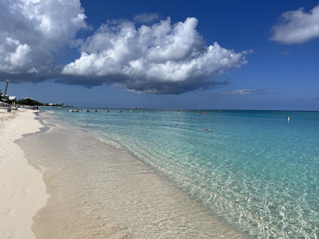 Wide white sand and calm clear turquoise water at Governors Beach on Seven Mile Beach Grand Cayman