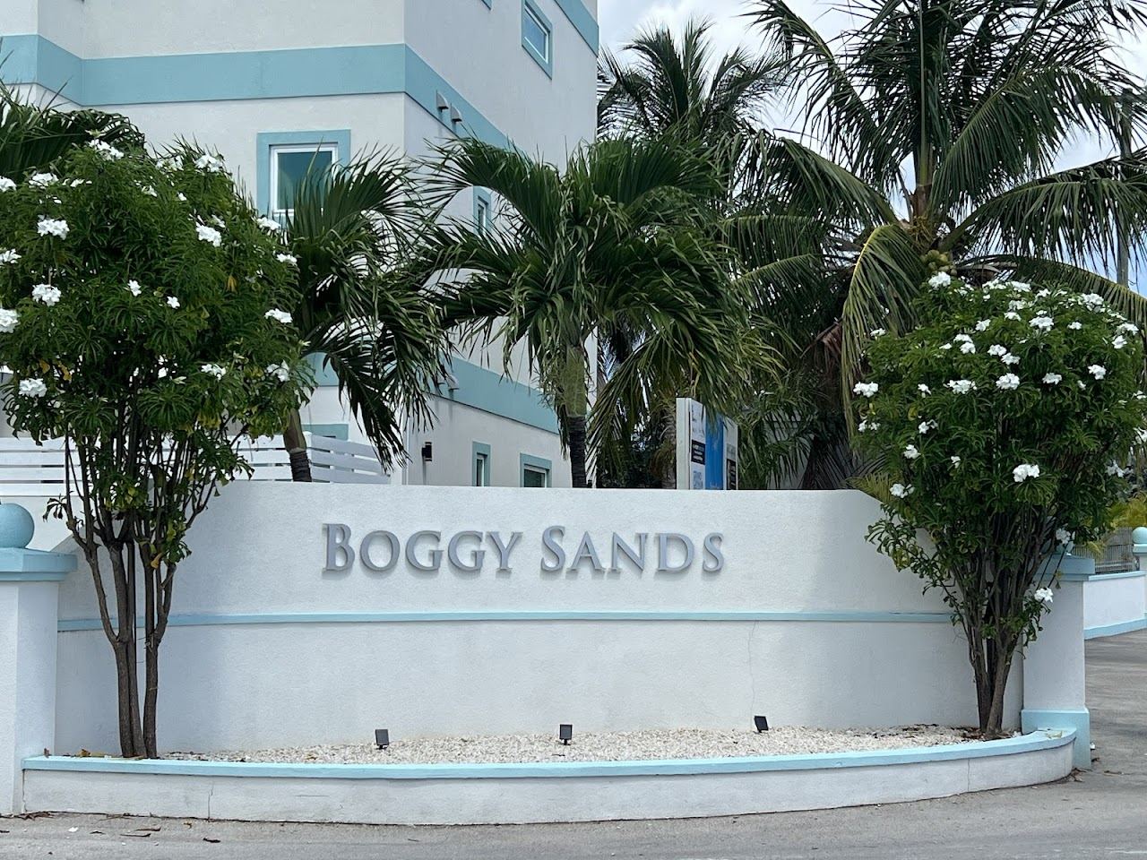 A beach bar and loungers on the calm turquoise frontage of Seven Mile Beach Grand Cayman