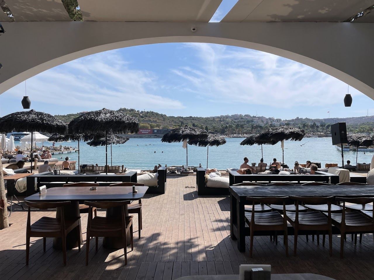 The wooden deck and sea platform of Paparazzi Beach Club over the water at Ayayorgi near Cesme