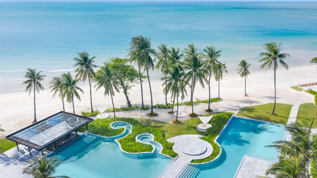 Loungers and palms along a resort frontage at Chaweng Noi Beach on Koh Samui