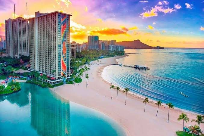 The high rise backed sand of Waikiki in Honolulu with Diamond Head in the distance