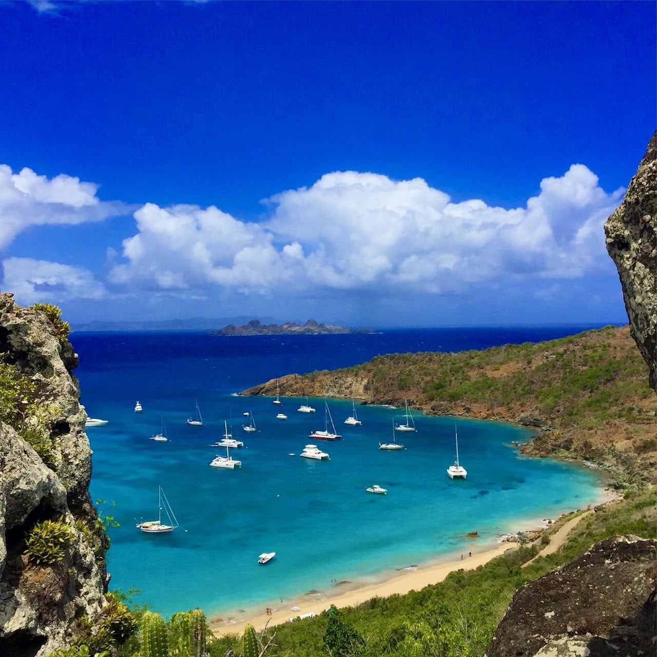 The remote turquoise cove of Colombier Beach on the north west tip of St Barths seen from the hillside