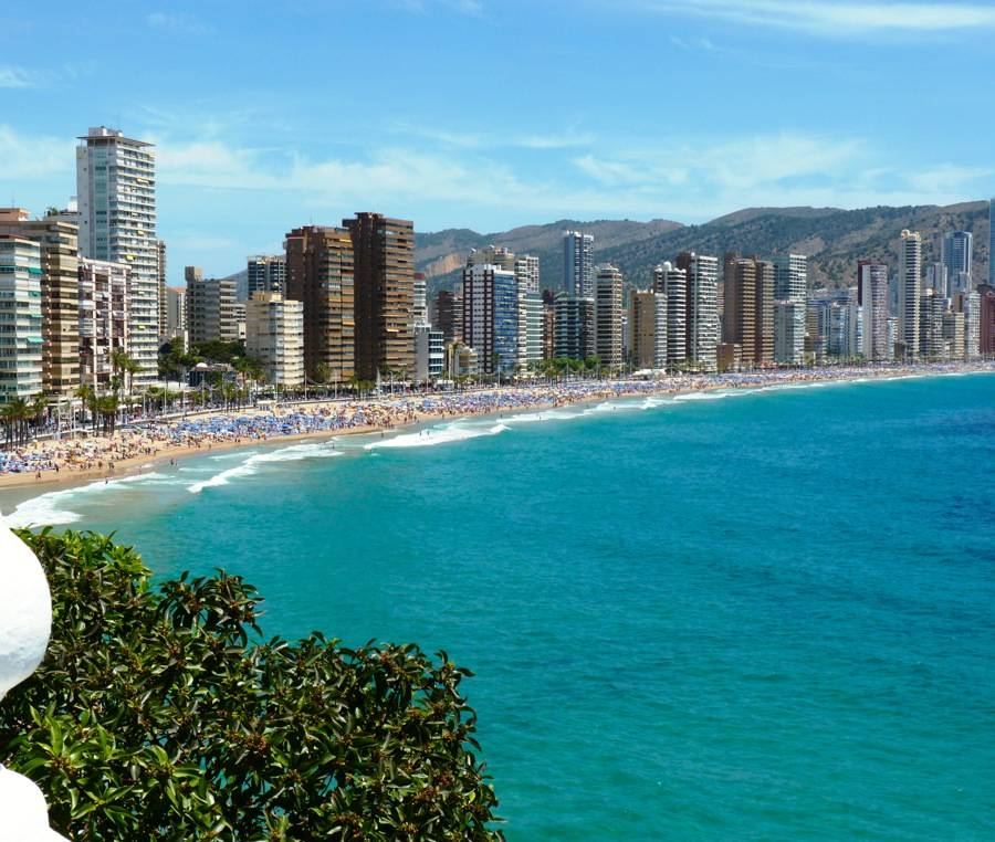 The wide town beach and seafront high rises of Playa de Levante in Benidorm on the Costa Blanca