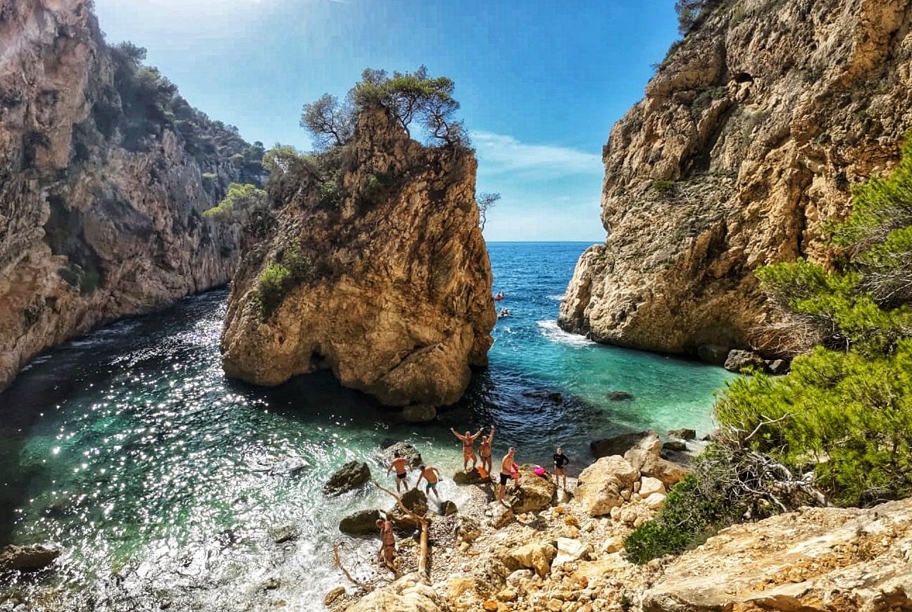 A quiet cove framed by pine covered cliffs on the Costa Blanca
