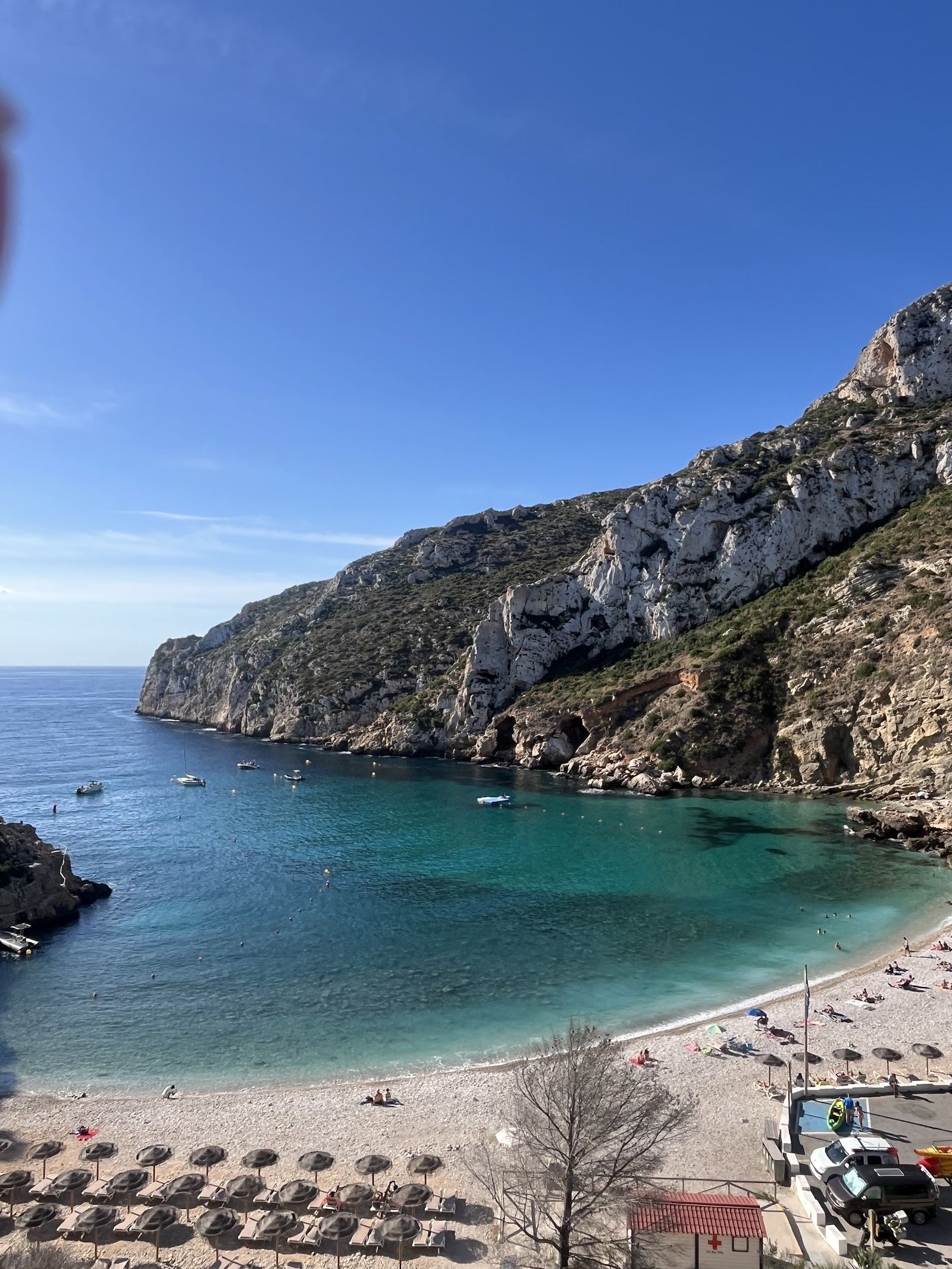 The clear turquoise water and pine covered cliffs of Cala Granadella near Javea on the Costa Blanca