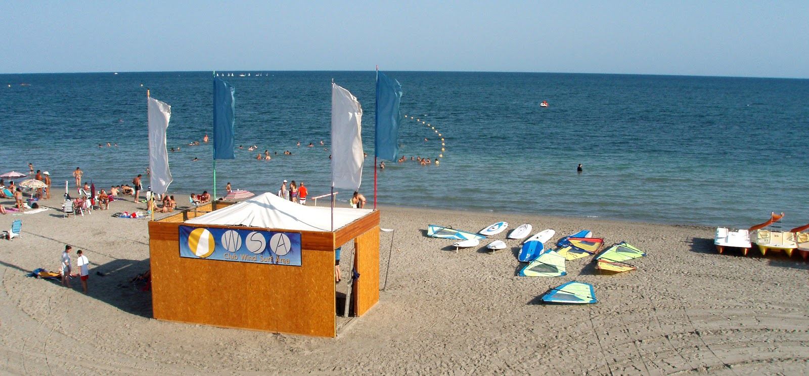 Windsurfers rigging on a wide open beach with steady wind on the Costa Blanca