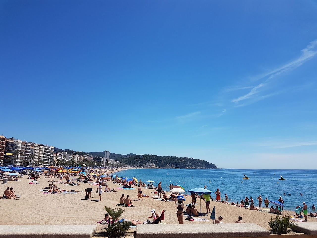 The wide town beach and promenade at Lloret de Mar on the Costa Brava