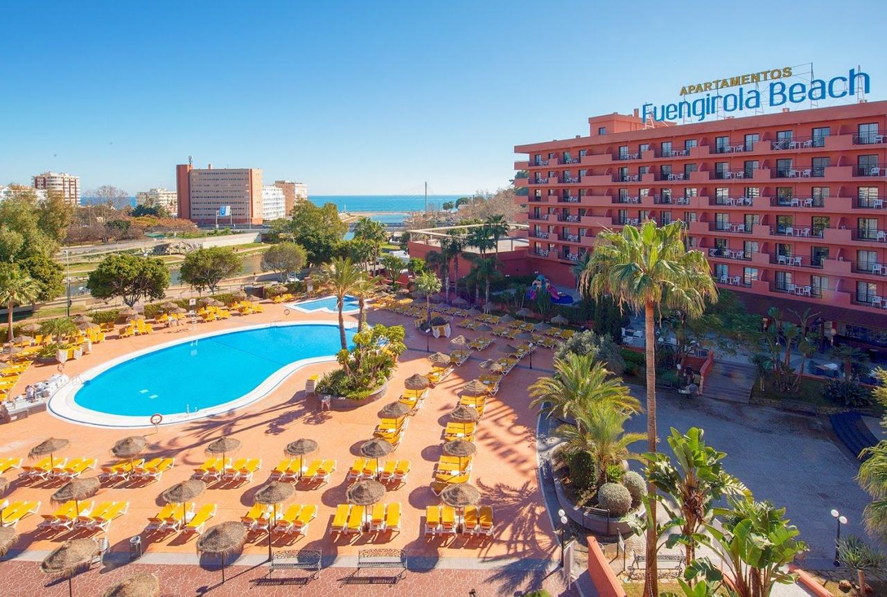 Long promenade and wide sandy beach beside calm water at Fuengirola on the Costa del Sol