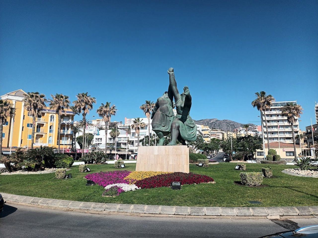 Wide town beach and calm water below the promenade at Torremolinos on the Costa del Sol