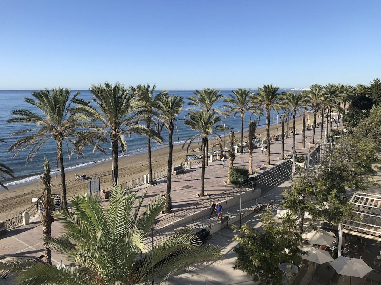Palm lined promenade and wide beach at Marbella on the Costa del Sol