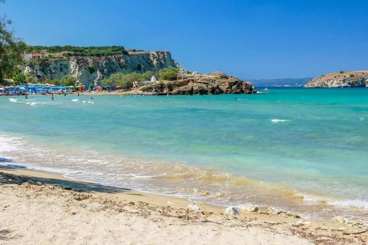 The shallow calm water and sandy shore at Almyrida beach in western Crete
