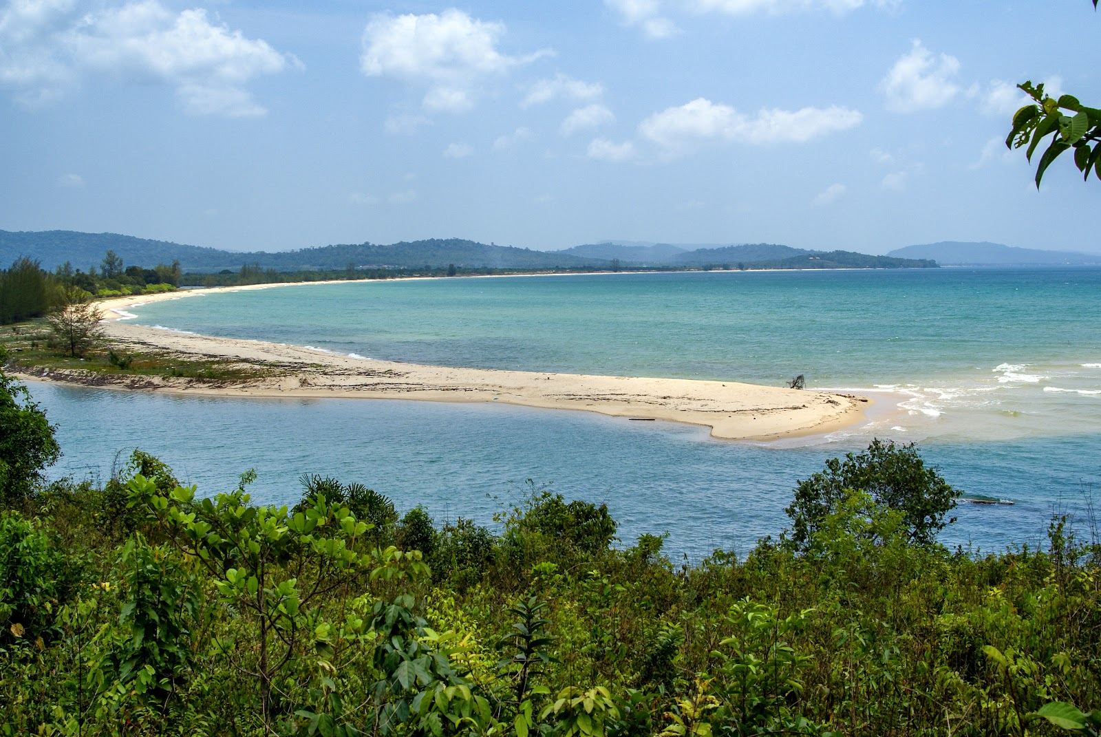 Quiet palm backed sand and calm shallow water where the Cua Can river meets the sea on the west coast of Phu Quoc