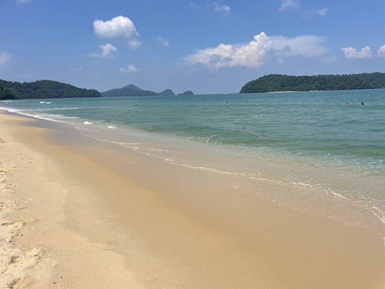 White sand and calm sea along Pantai Tengah beach on Langkawi's southwest coast