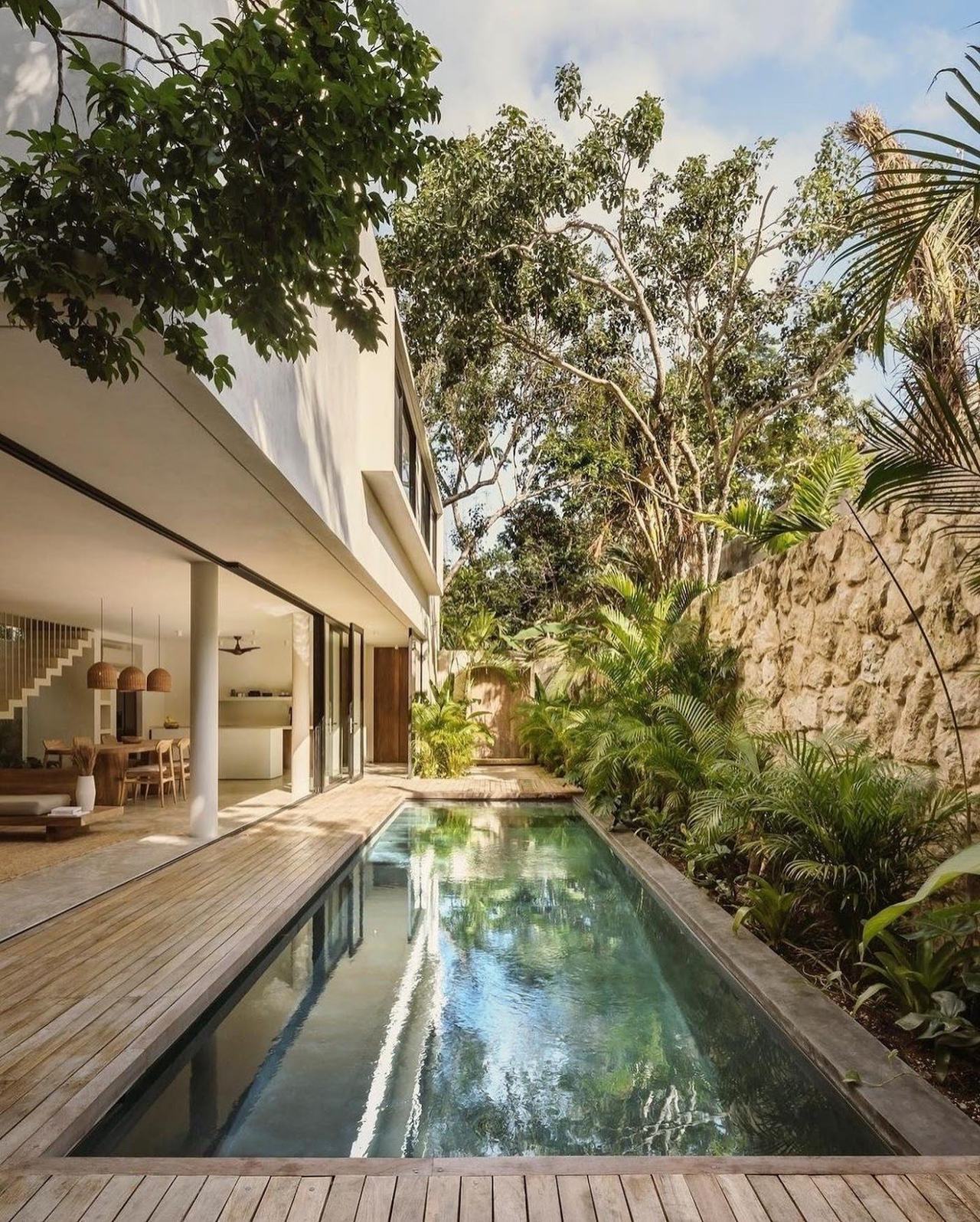 A boho beach of palms and white sand backed by jungle on the Caribbean coast of Mexico