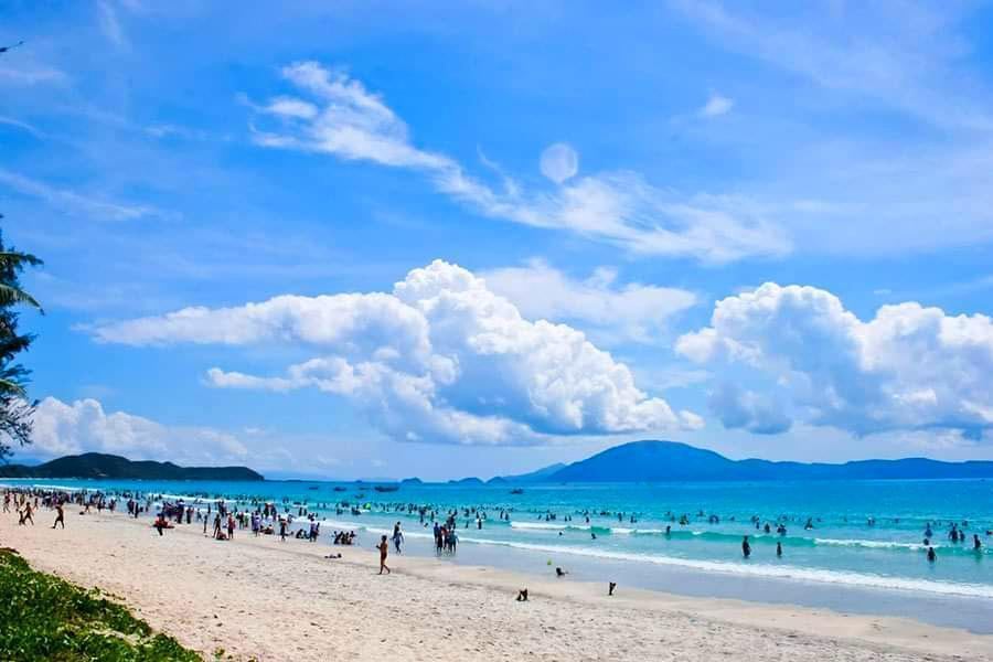 Pale white sand and shallow calm water at Doc Let Beach north of Nha Trang in Vietnam