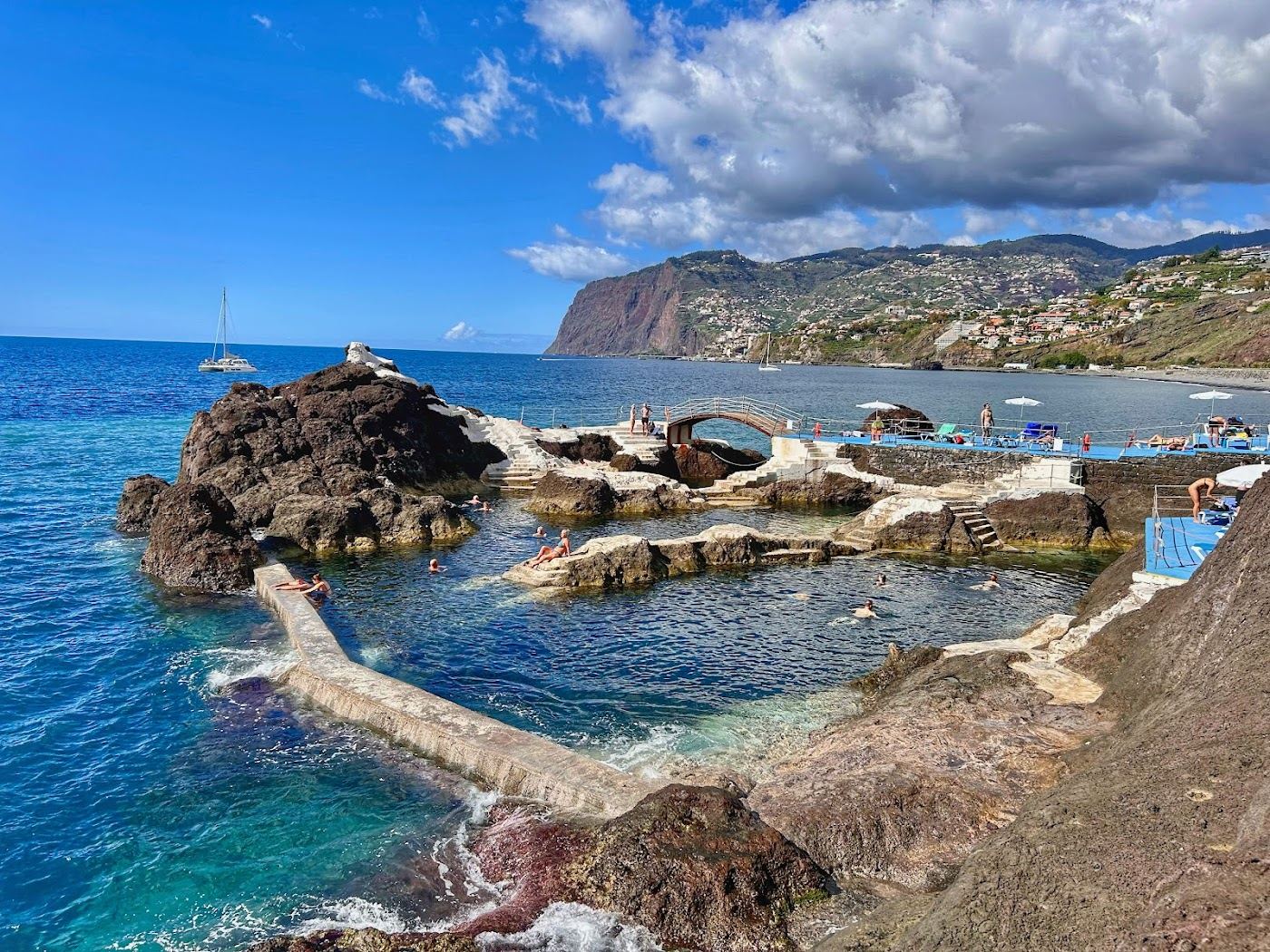 Natural seawater pools set into black volcanic rock below the Lido promenade at Doca do Cavacas in Funchal
