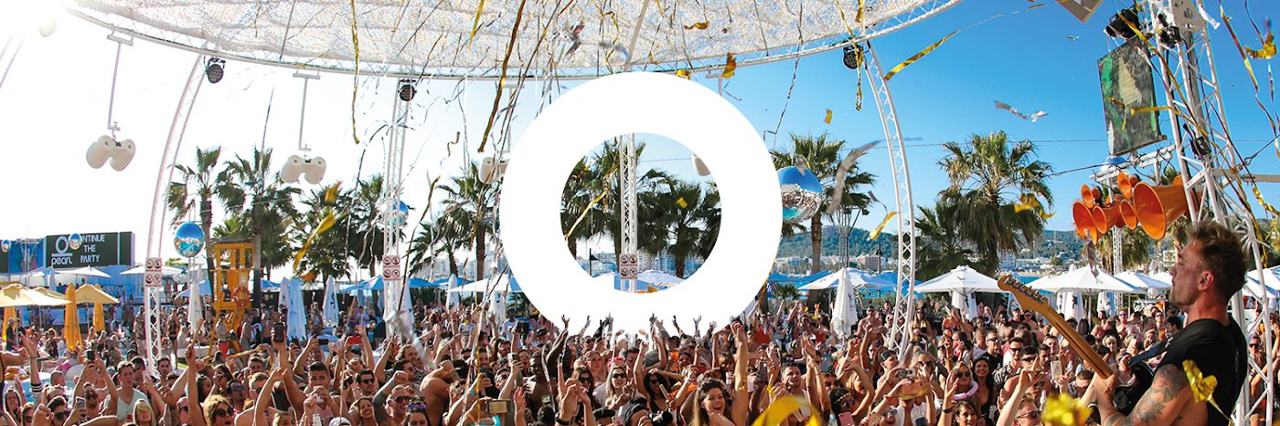 Pool, daybeds and a party crowd at O Beach Ibiza in San Antonio