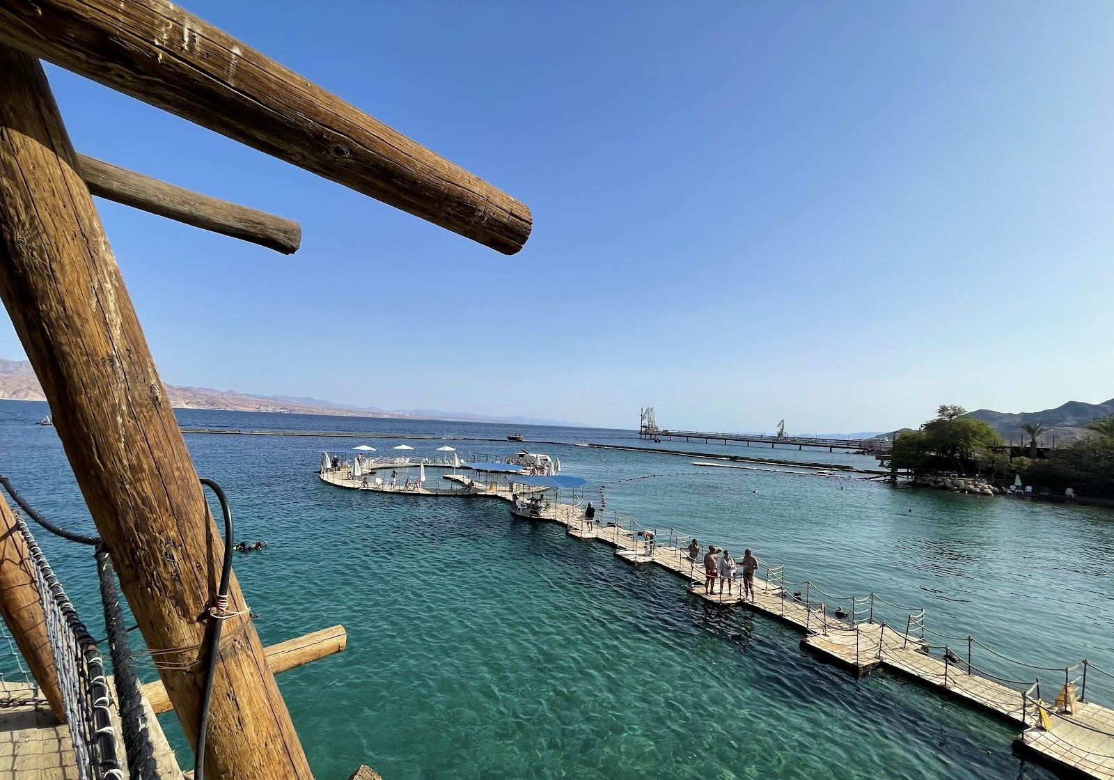 Calm shallow Red Sea water and desert mountains on a sheltered Eilat beach