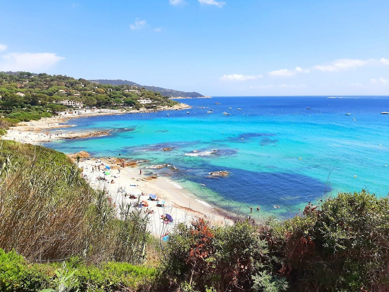 Wild part sand part pebble cove with clear water at Plage de l'Escalet near Ramatuelle France