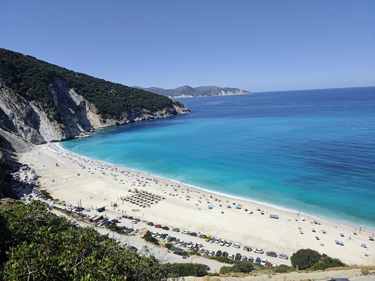 The bright white pebbles and deep blue water below cliffs at Myrtos on Kefalonia