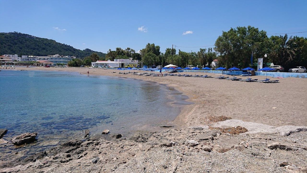 View along the long sandy beach and calm blue water of the Faliraki resort strip on the east coast of Rhodes