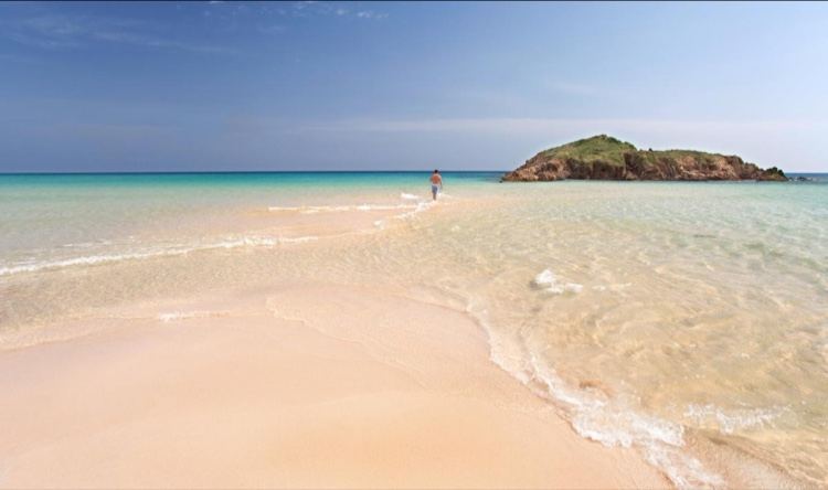 The shallow turquoise flats off the sandbar at Su Giudeu near Chia