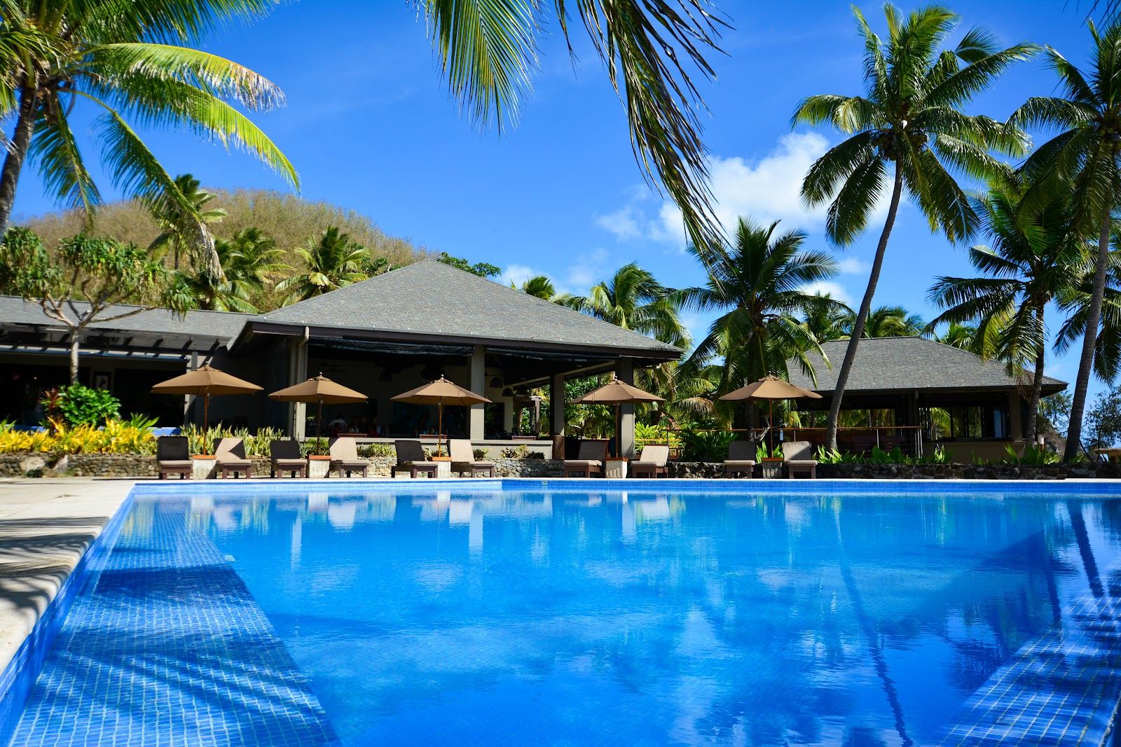 Turquoise lagoon and white sand fringed by palms in the Yasawa Islands of Fiji